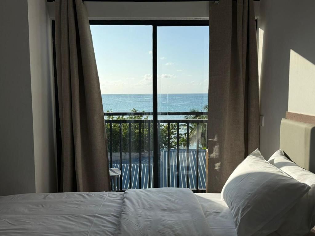 Bedroom with balcony and sea view at VillaBlu Dhiffushi